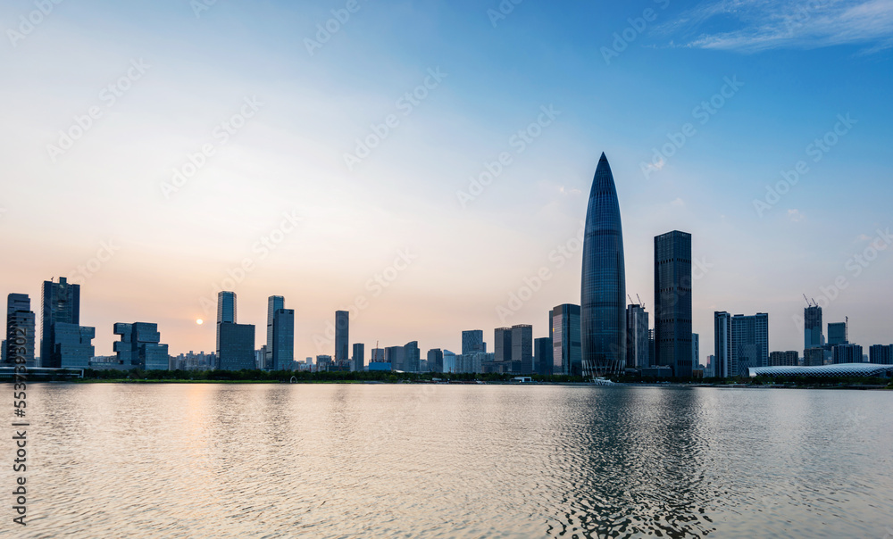 Naklejka premium Office building reflected in the water at sunset