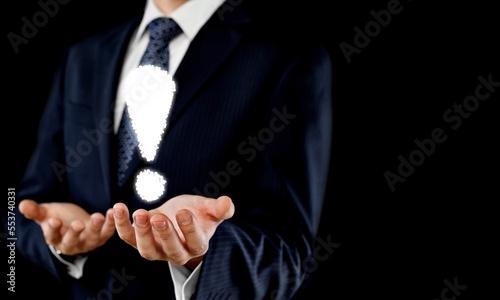 Male business worker hand with exclamation mark