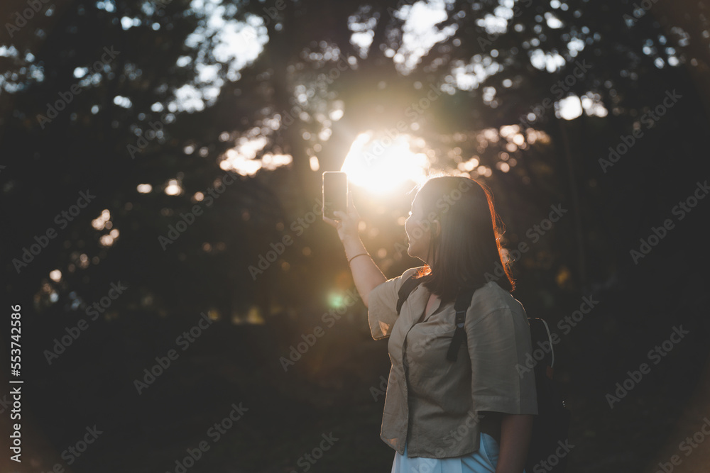 Female tourist holding a backpack holding a smartphone taking a selfie. Lifestyle, adventure, outdoor nature lifestyle. happy sunshine photography exciting mood lovely photography Female tourist holding a backpack holding a smartphone taking a selfie. Lifestyle, adventure, outdoor nature lifestyle. happy sunshine photography exciting mood lovely photography
