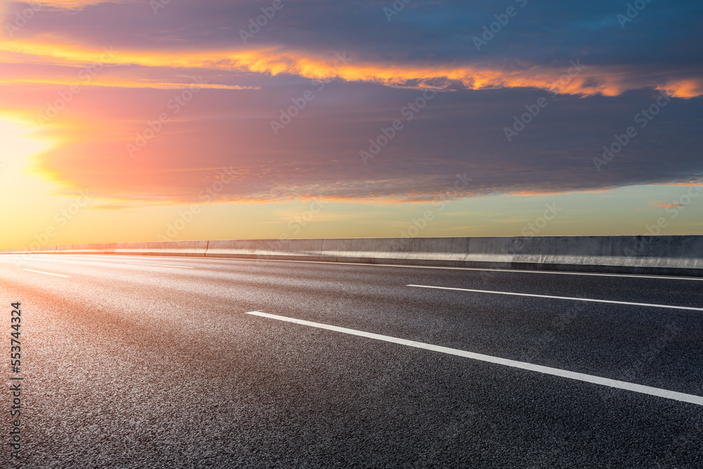 Asphalt road and sky clouds at sunrise. Road and sky background. Asphalt road and sky clouds at sunrise. Road and sky background.