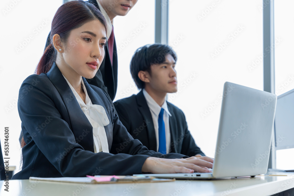A group of young Asian businessmen Talking and planning work happily and have fun. at the company's office A group of young Asian businessmen Talking and planning work happily and have fun. at the company's office