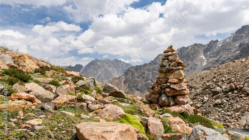 a stone pyramid in the mountains on the trail. indicator © Daniil_98_03_09