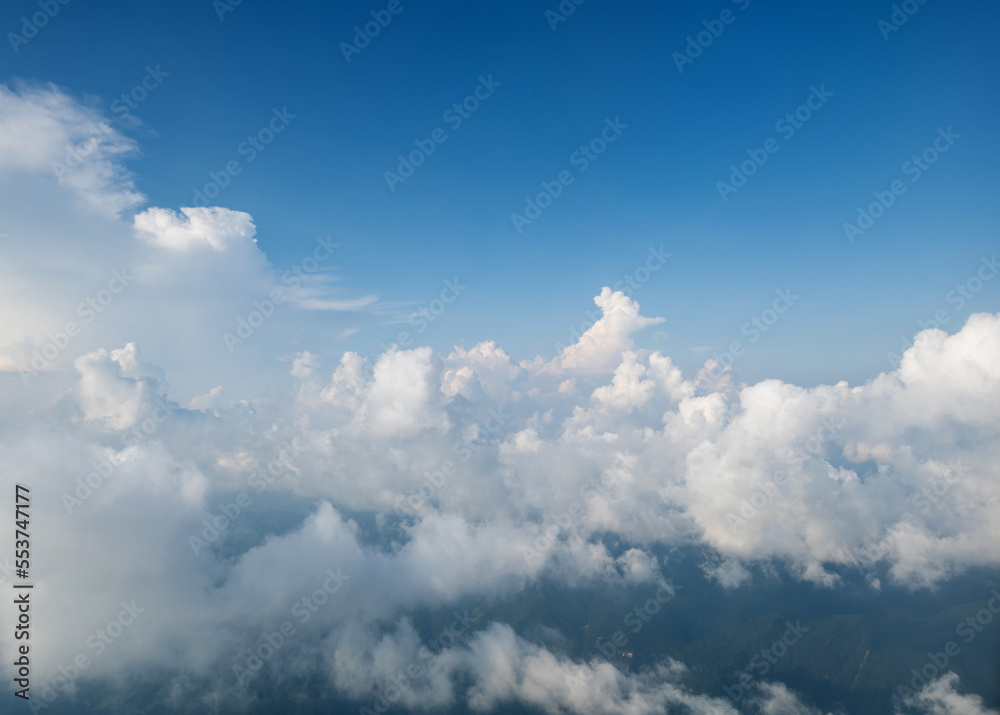 Aerial view clouds and blue sky from airplane window Aerial view clouds and blue sky from airplane window