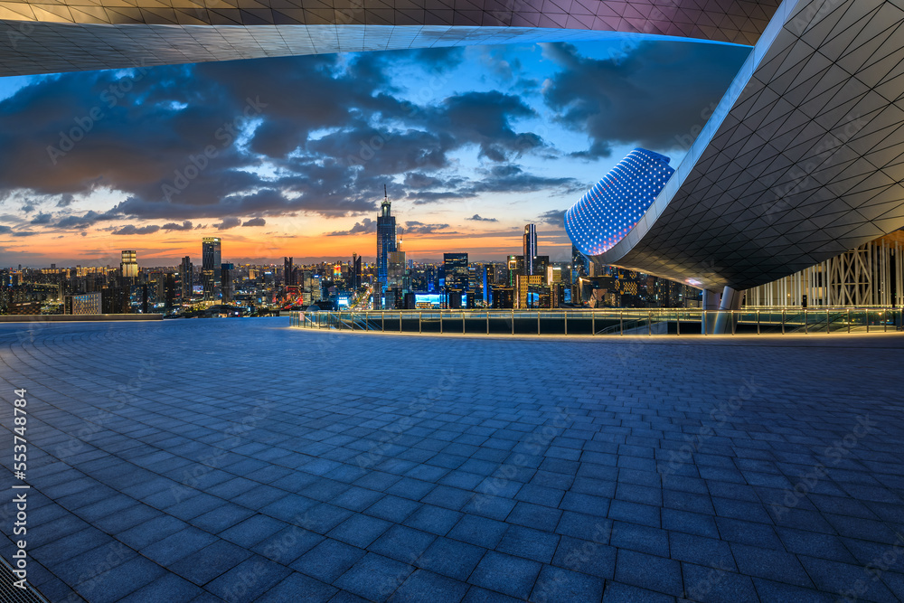 Empty square floor and modern city skyline with buildings at night in Ningbo, Zhejiang Province, China.