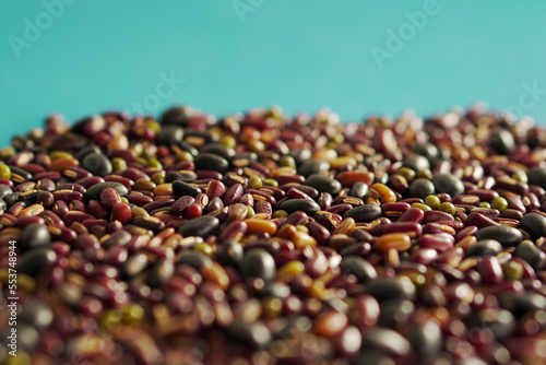 Assortment of many kinds of beans on blue background