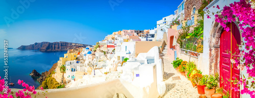 traditional greek village Oia of Santorini, street against Aegan sea and caldera, Greece, web banner format
