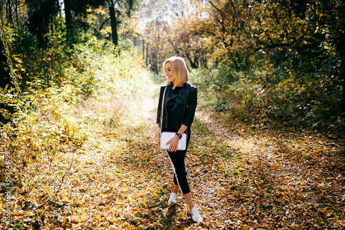 young girl walking in autumn park