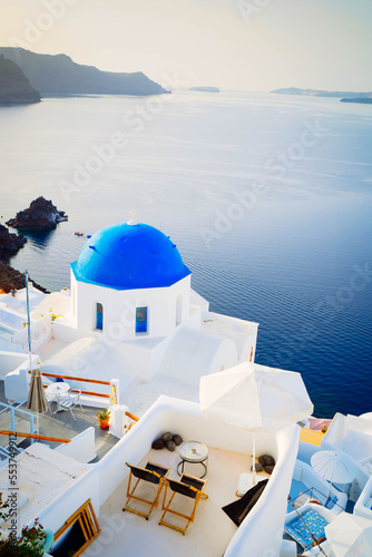 traditional greek village Oia of Santorini, with blue domes of churches and village roofs, Greece, toned