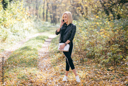 young girl walking in autumn park