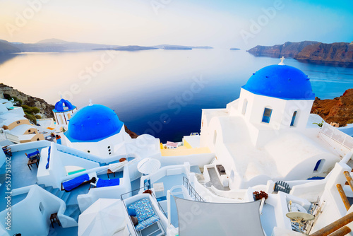 traditional greek village Oia of Santorini, with blue domes of churches and village roofs, Greece, toned