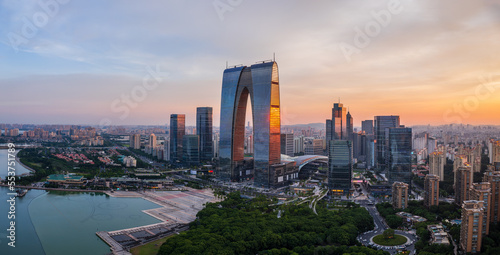 Aerial view of city skyline and modern buildings in Suzhou at sunset, China.
