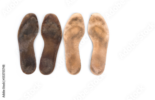 Heavy used insoles on a white background