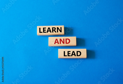 Learn and lead symbol. Concept words 'Learn and lead' on wooden blocks. Beautiful blue background. Business and Learn and lead concept. Copy space.