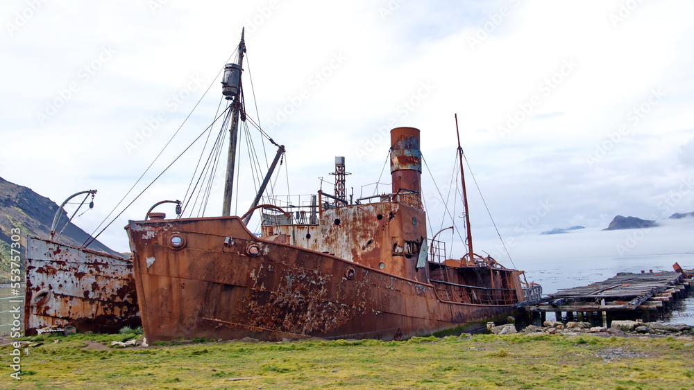 Old, rusted whaling and sealing ship by an old pier at the old whaling station at Grytviken, South Georgia Island