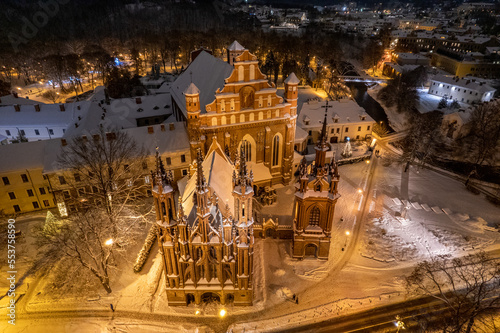 Aerial winter snowy night view of St. Anne's Church (Onos baznycia) Vilnius old town, Lithuania photo