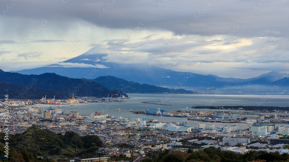 Mount Fuji and Shizuoka city with commercial cargo port foreground in the morning  in japan, selective focus on fuji mountain