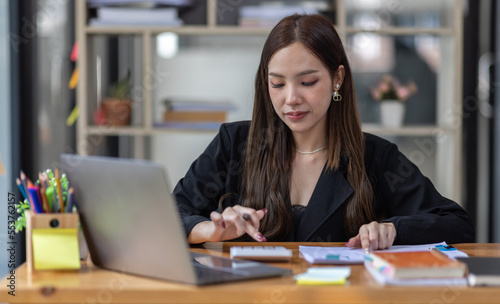 Portrait of business asian woman Accounting using calculating income-expenditure and analyzing real estate investment data report Financial and tax systems concept. 