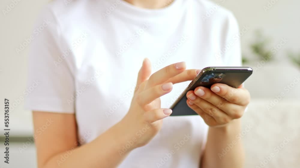 Woman hands is using phone swiping up social media. Plays mobile games app or chooses things online shopping. Woman hands is using phone swiping up social media. Plays mobile games app or chooses things online shopping.