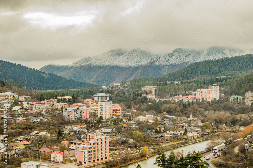 aerial view of town with snow-capped mountain