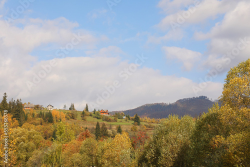 Beautiful forest and mountain village on autumn day