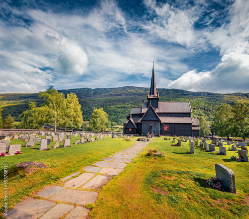 Sunny summer view of Lom stave church (Lom Stavkyrkje). Adorable morning scene of Norwegian countryside, administrative centre of Lom municipality - Fossbergom, Norway, Europe.