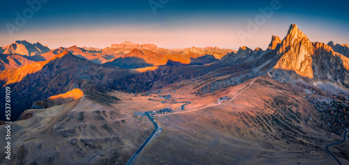 Panoramic autumn view from flying drone of Giau pass, province of Belluno in Italy, Europe. Astonishing morning sunrise in Dolomite Alps. Beauty of nature concept background..