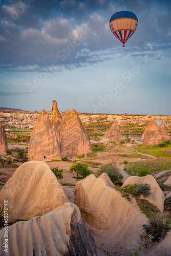Flying on balloons early morning in Cappadocia. Stunning summer scene of Red Rose valley, Goreme village location, Turkey, Asia. Traveling concept background.