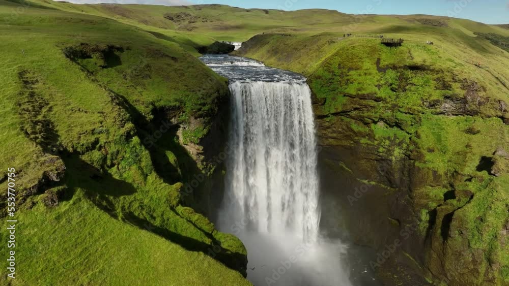 Skogafoss waterfall in Iceland summer day aerial shot summer day green grass sunny day 