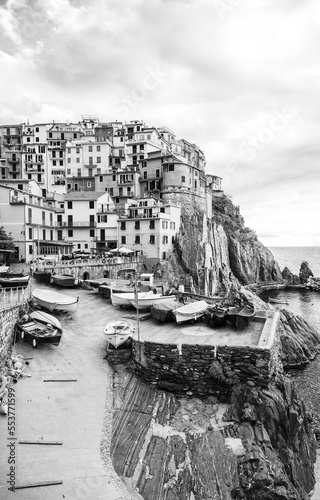 Italian town on the coast against the backdrop of the sea and the sky with clouds. Black and white photo photo