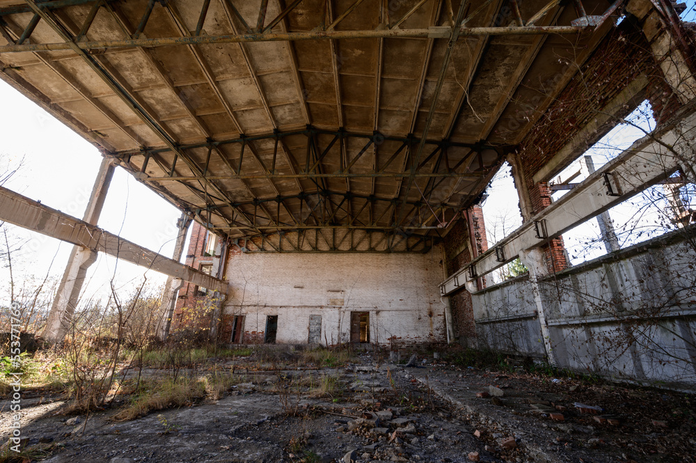 An abandoned warehouse that has been destroyed by people and time.
