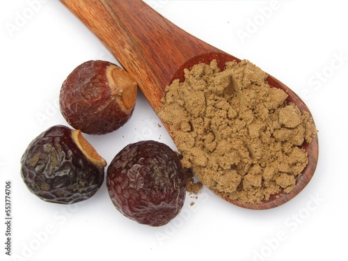 Sapindus mukorossi or Indian soapberry powder on wooden spoon  photo