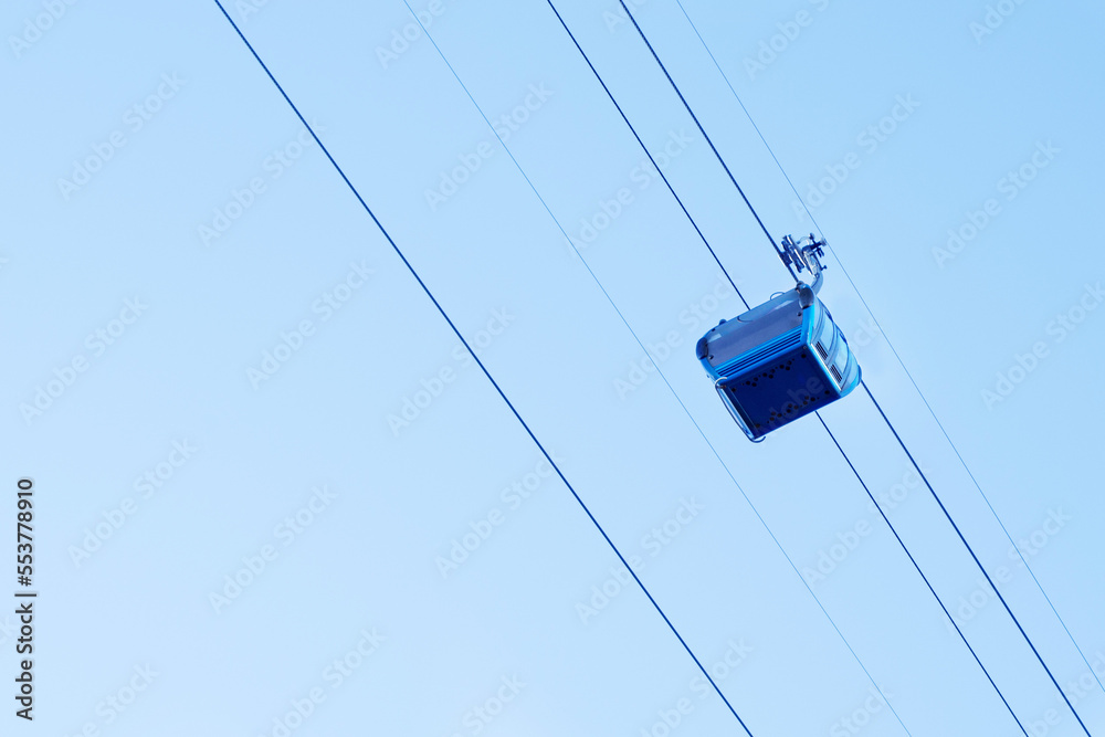 Cable car in Batumi, Georgia. Blue cabin move on the cable car against the sky