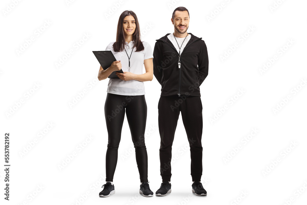 Full length portrait of a female and male sport coaches Full length portrait of a female and male sport coaches