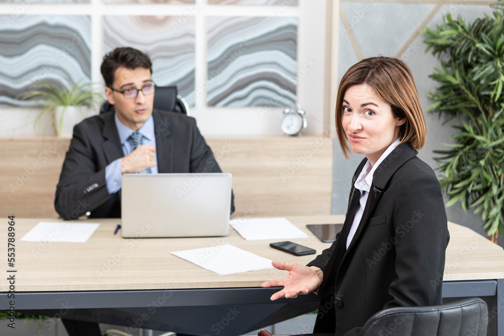 Confused woman in suit feeling stress on interview in the office Confused woman in suit feeling stress on interview in the office