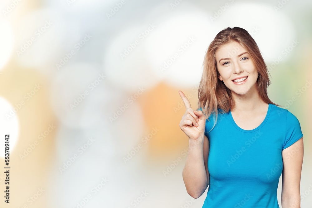 Happy cute young lady posing on bokeh background. Happy cute young lady posing on bokeh background.
