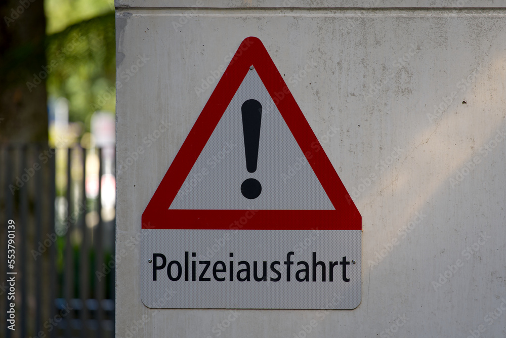 Warning sign with german text Polizeiausfahrt, translation ist police exit, at City of Chur, Canton Graubünden, on a blue cloudy autumn noon. Photo taken September 26th, 2022, Chur, Switzerland.
