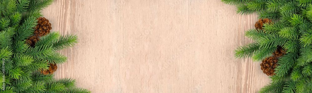 Christmas wooden background with fir tree.Light brown wooden background. Christmas decor, garland with Rustic Background