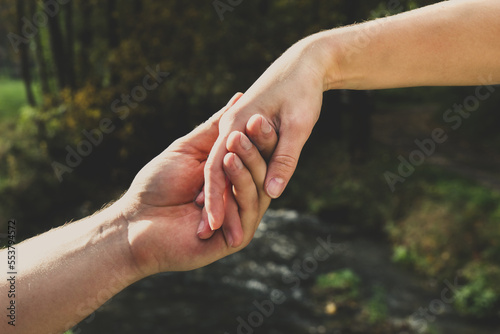 A man's hand holds a woman's hand © Bogdan