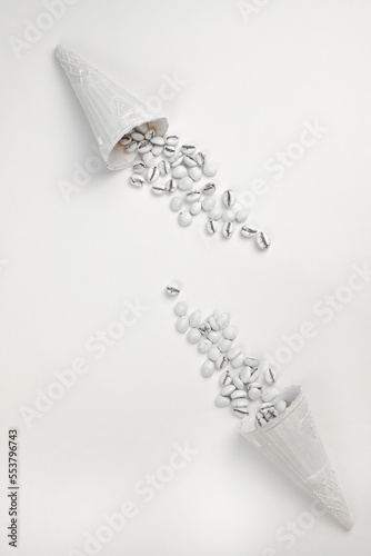 in white wafer cones for ice cream fragrant white coffee grains on a white background. for labels, signs, postcards, announcements and more
