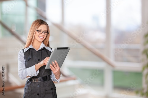 Young woman journalist in office with digital tablet