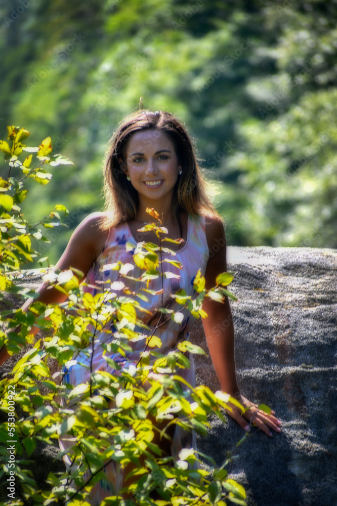 Photographs of model in nature relaxing on large rock Photographs of model in nature relaxing on large rock