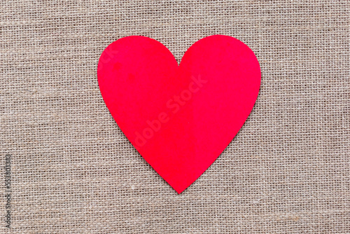 Paper craft heart on a burlap background. Valentine flat lay with red heart.