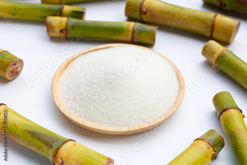 Sugar with sugar cane on white background.