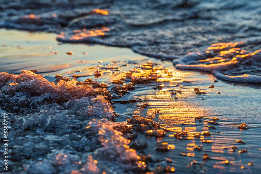 Close-up of ice on the beach at sunset. Pörkenäs, Österbotten/Pohjanmaa. Finland. Close-up of ice on the beach at sunset. Pörkenäs, Österbotten/Pohjanmaa. Finland.