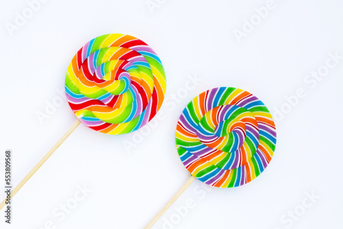 Rainbow lollipop on white background.