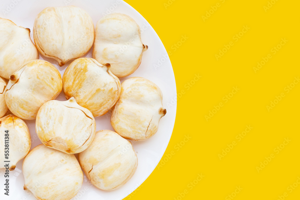 Toddy palm in white plate on yellow background.