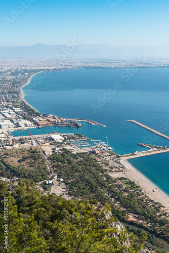 top view of the bay and resort Turkish city of Antalya against the backdrop of mountains and blue sky