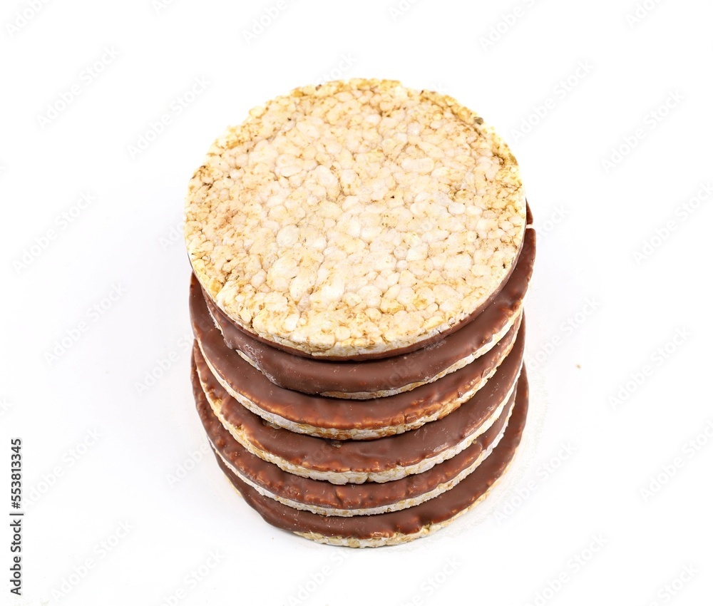 Stack of puffed rice diet crackers with chocolate on white background. Circle shaped, copy space. Stack of puffed rice diet crackers with chocolate on white background. Circle shaped, copy space.