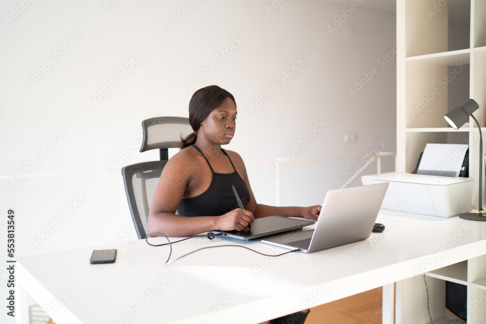Black illustrator drawing on graphic tablet Black illustrator drawing on graphic tablet