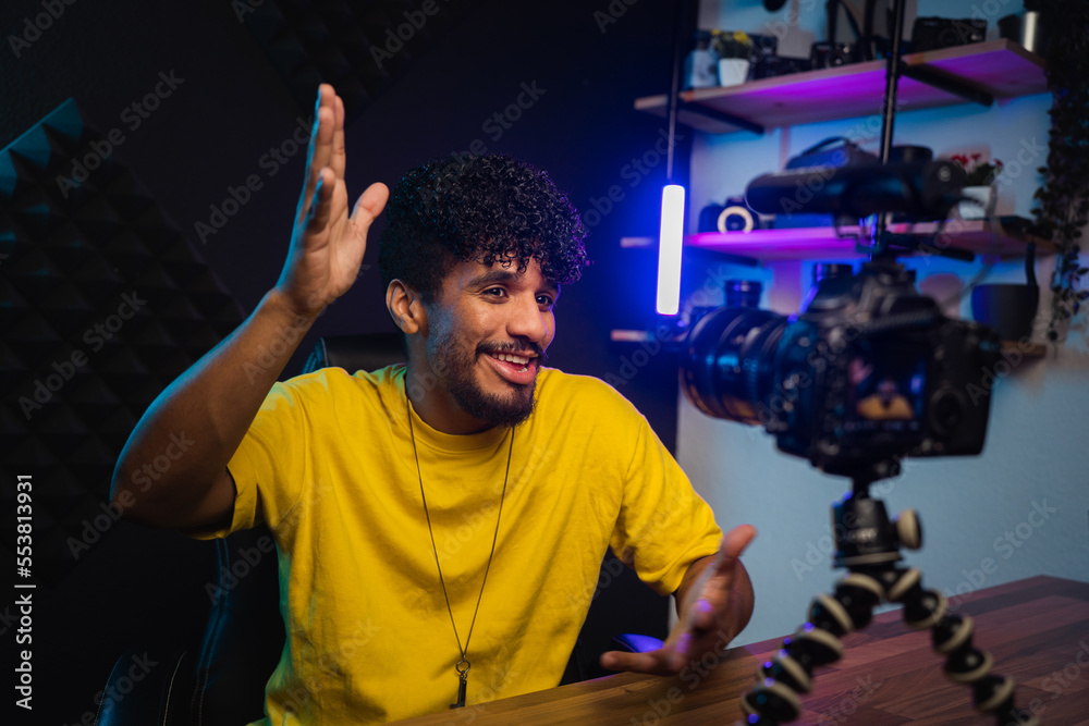 Cheerful Hispanic man shooting video for vlog Cheerful Hispanic man shooting video for vlog
